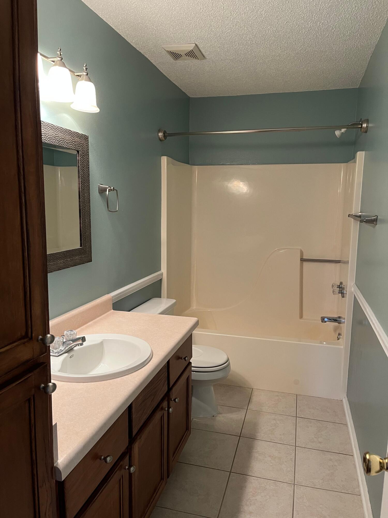 2260 Estate Circle Navarre, FL 32566 - Photo 4 of 14 a bathroom with a sink a toilet and shower