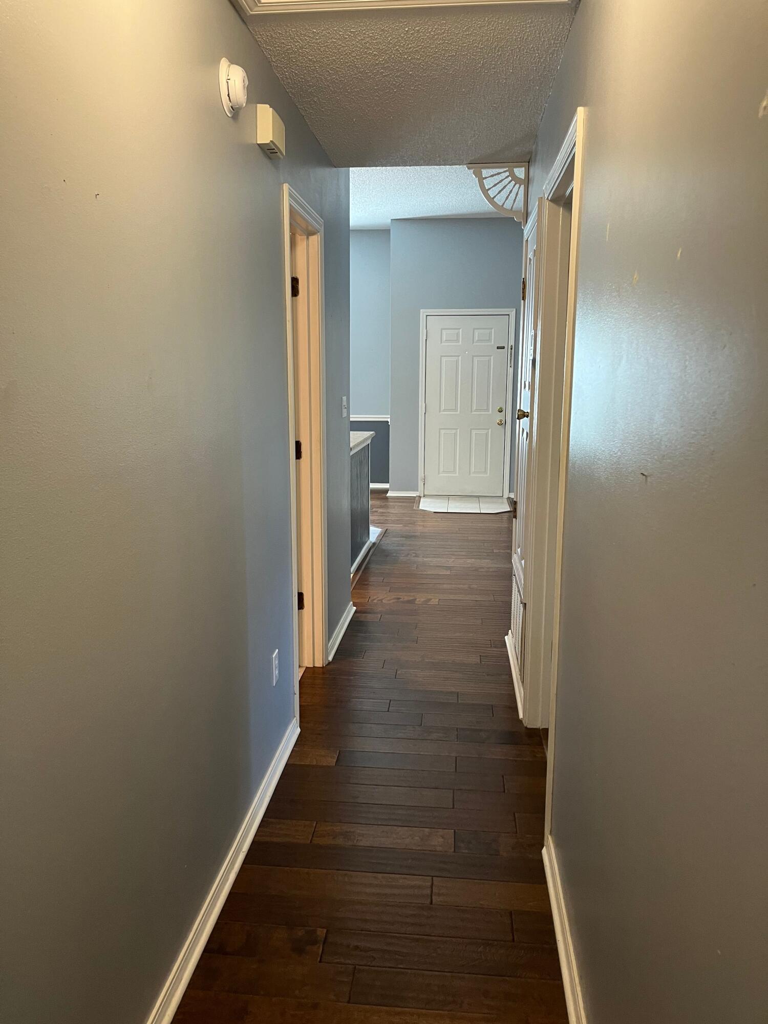 2260 Estate Circle Navarre, FL 32566 - Photo 6 of 14 a view of a hallway with wooden floor and staircase