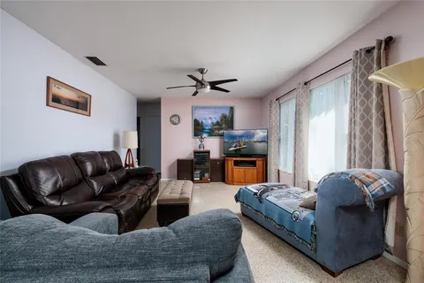 a living room with fireplace furniture and a chandelier