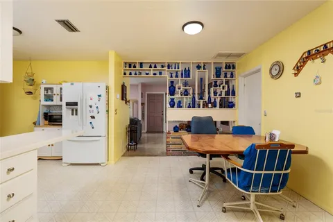 a room with furniture a dining table and chairs