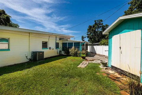 a view of a house with backyard and sitting area