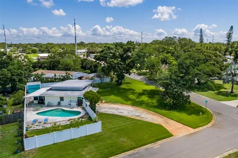 a view of a swimming pool with a yard