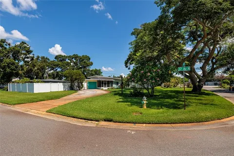 a view of a house with a backyard