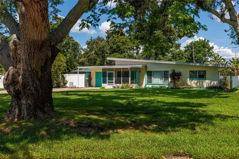 a front view of house with yard and green space