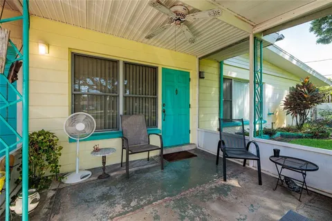 a living room with patio furniture and a grill