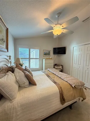 a bedroom with a bed and a television