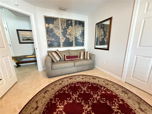 a living room with a couch and a rug