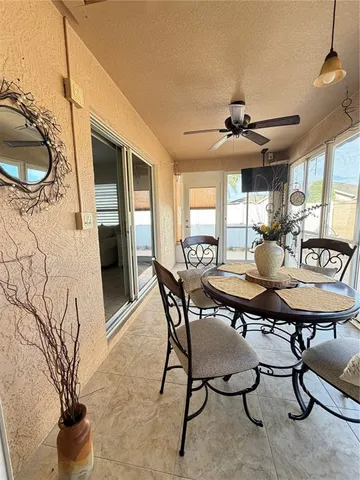 a view of a dining room with furniture and window