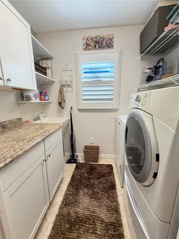 a kitchen with a sink a washer and dryer