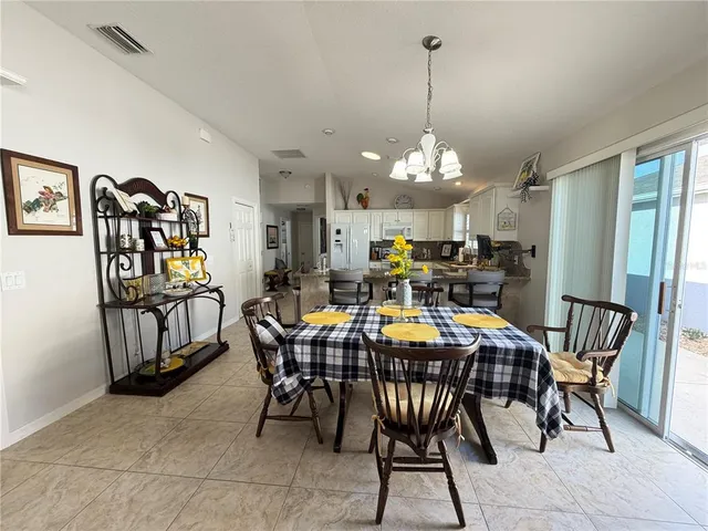 a view of a dining room with furniture and a chandelier