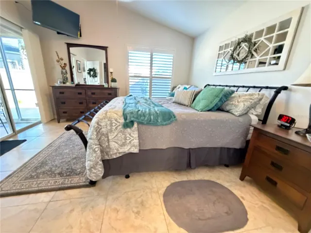 a bedroom with a bed and dresser with mirror