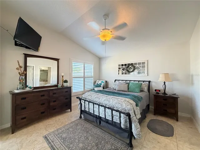 a bedroom with a bed and a television