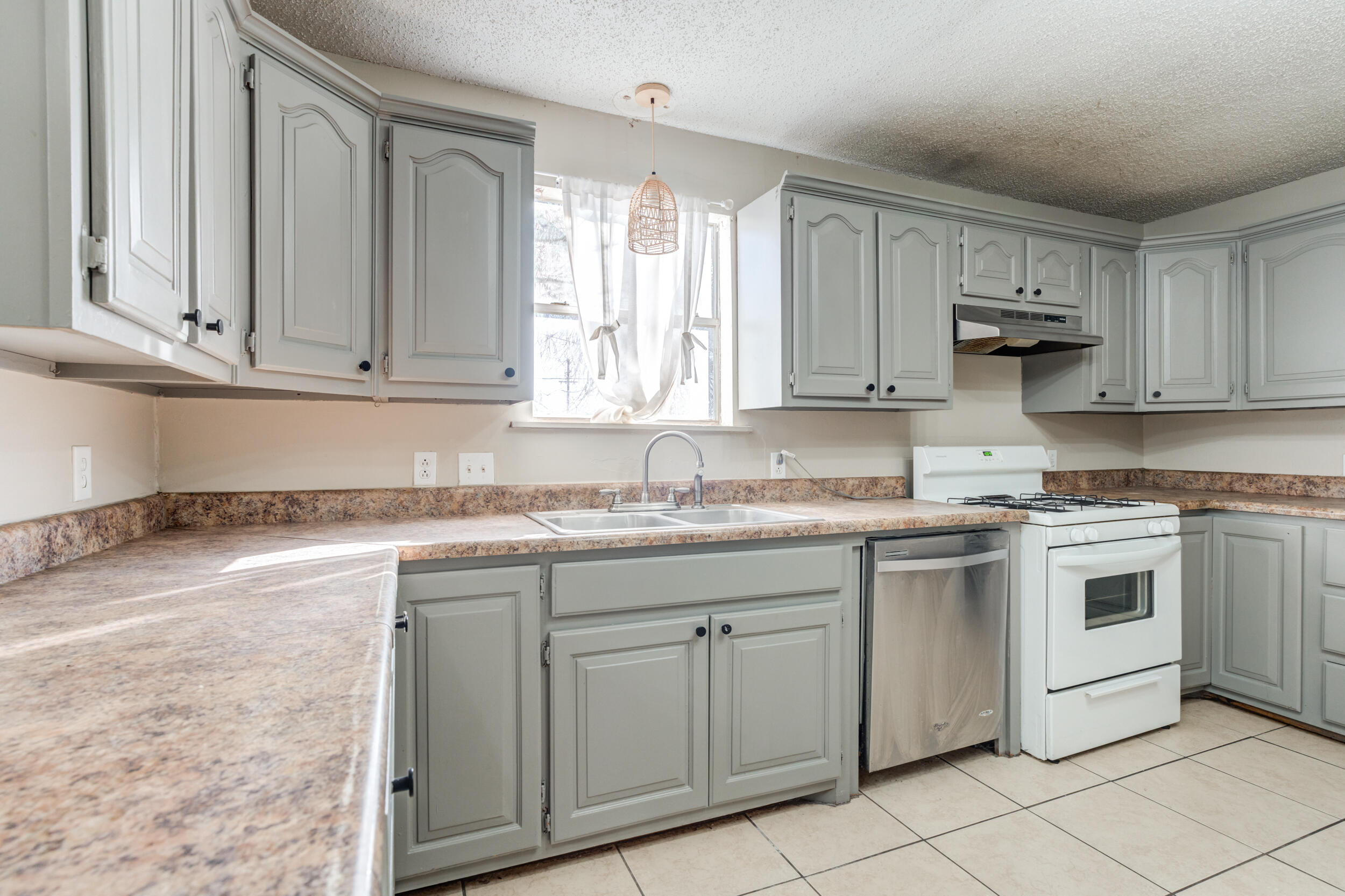 3109 Harvard Street Lubbock, TX 79415 - Photo 11 of 29 a kitchen with granite countertop cabinets stainless steel appliances and a sink