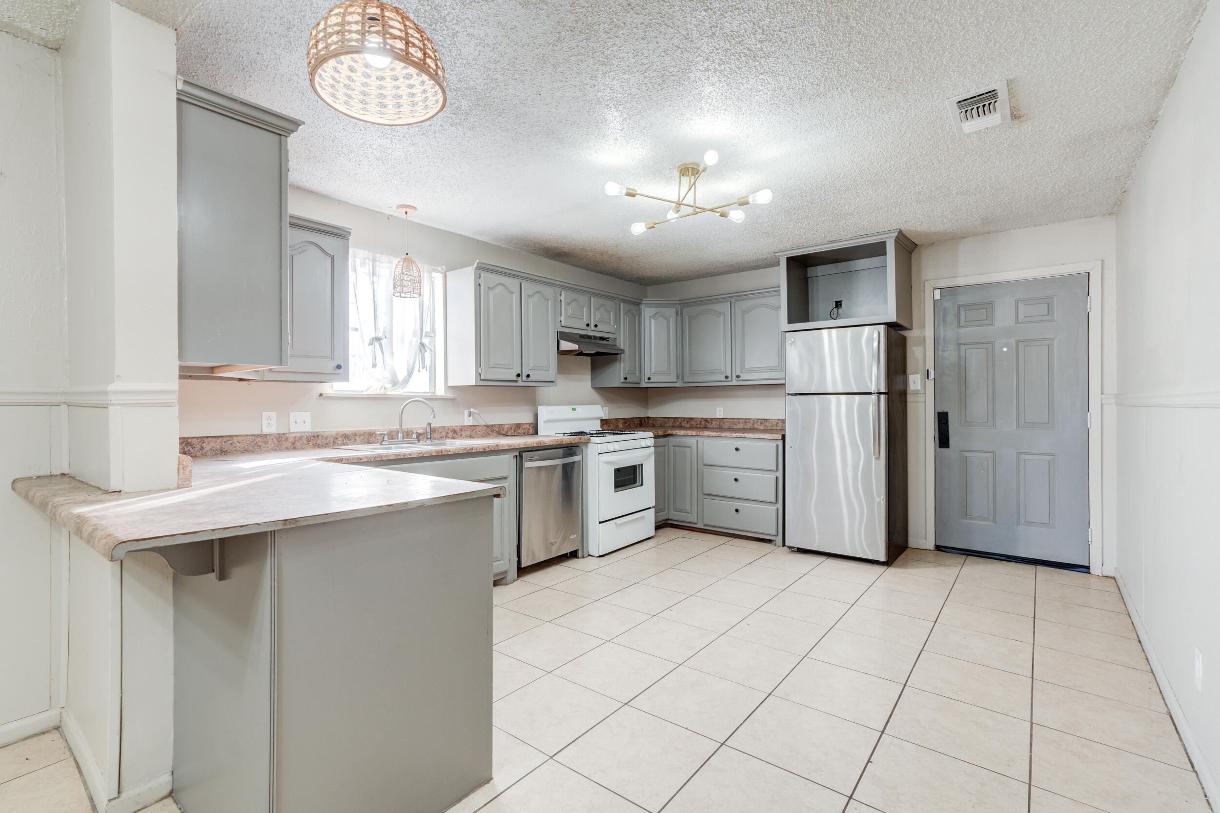 3109 Harvard Street Lubbock, TX 79415 - Photo 12 of 29 a kitchen with white cabinets and white appliances