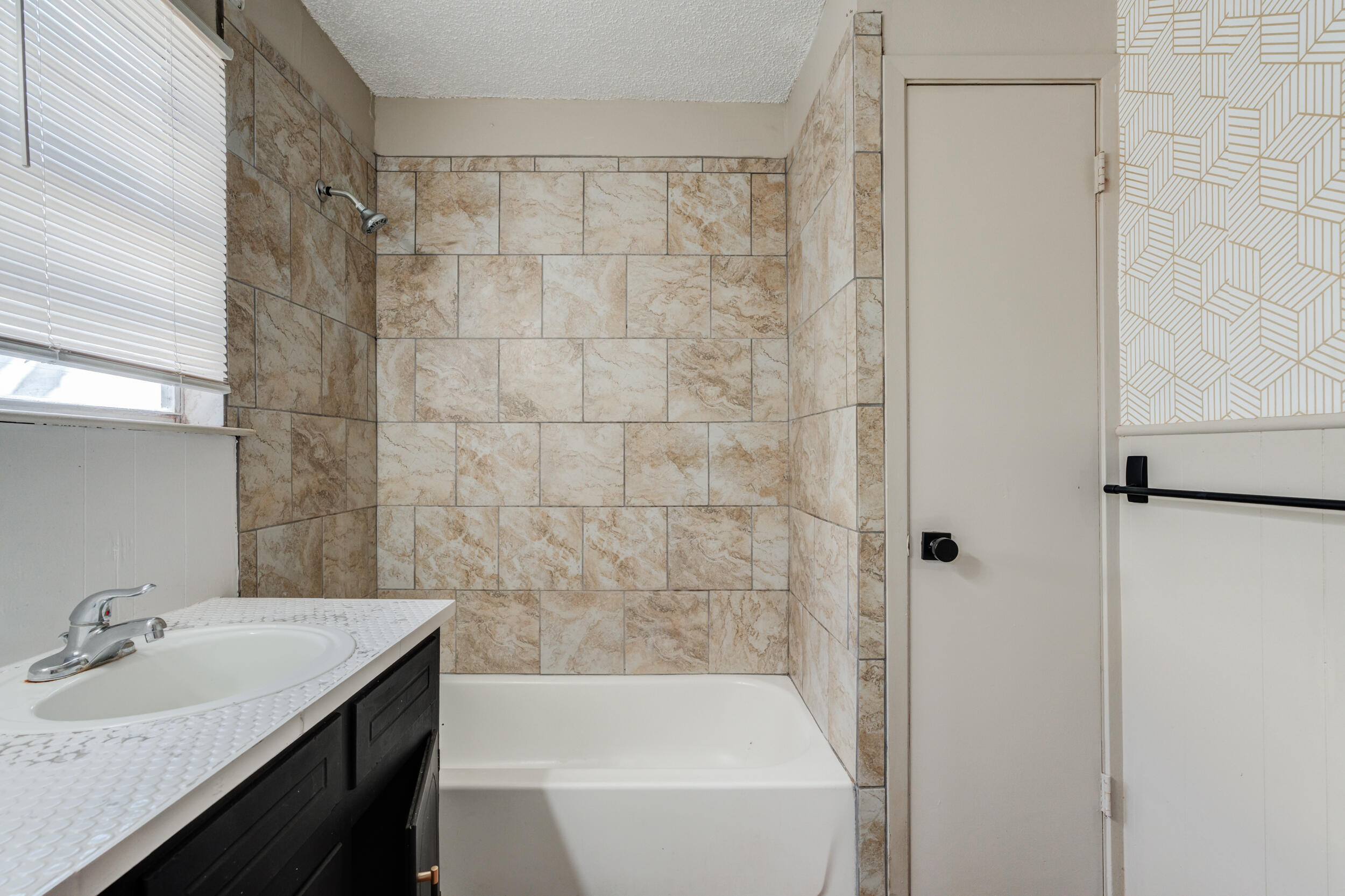 3109 Harvard Street Lubbock, TX 79415 - Photo 16 of 29 a bathroom with a sink and a bathtub