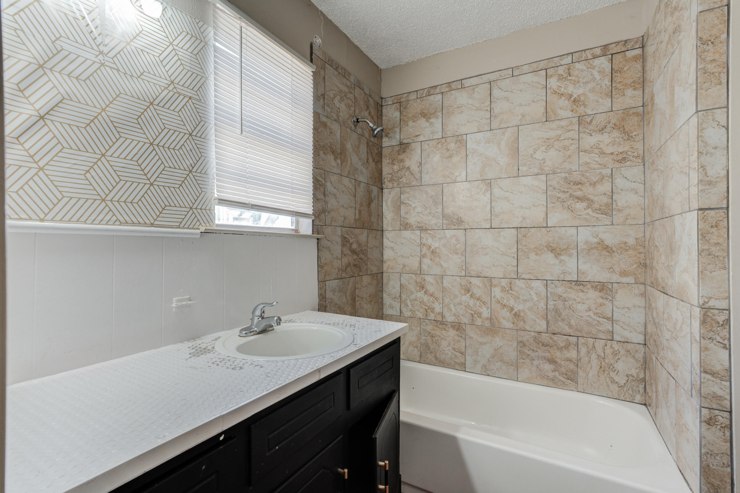 3109 Harvard Street Lubbock, TX 79415 - Photo 17 of 29 a bathroom with a sink and a bathtub