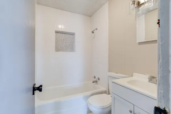 a bathroom with a sink a toilet and bathtub