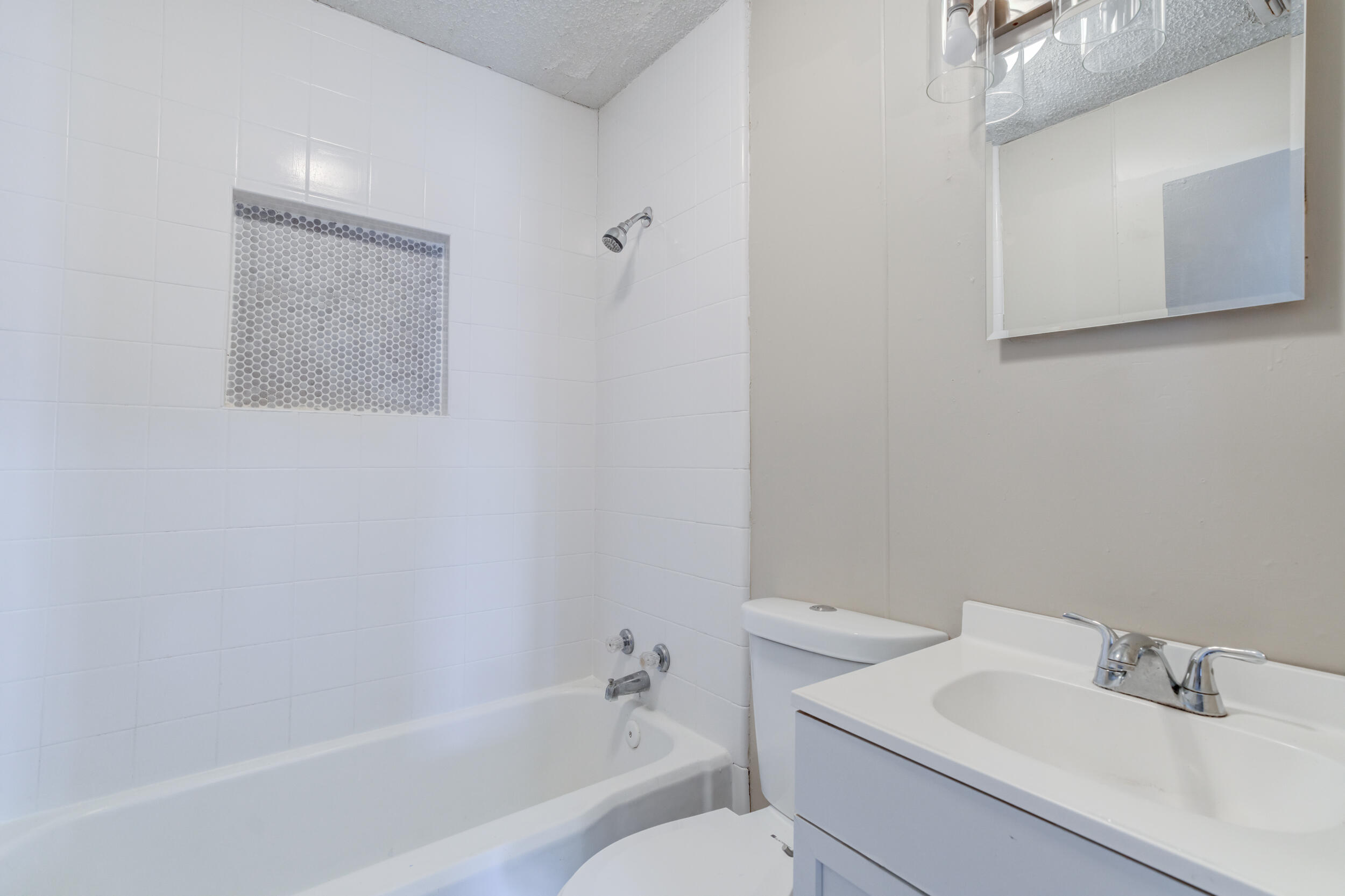3109 Harvard Street Lubbock, TX 79415 - Photo 21 of 29 a white bath tub sitting next to a white sink and vanity