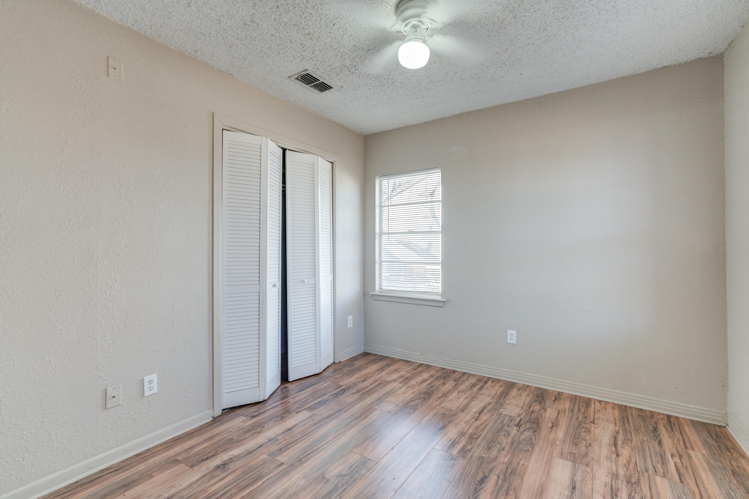 3109 Harvard Street Lubbock, TX 79415 - Photo 27 of 29 an empty room with wooden floor and windows