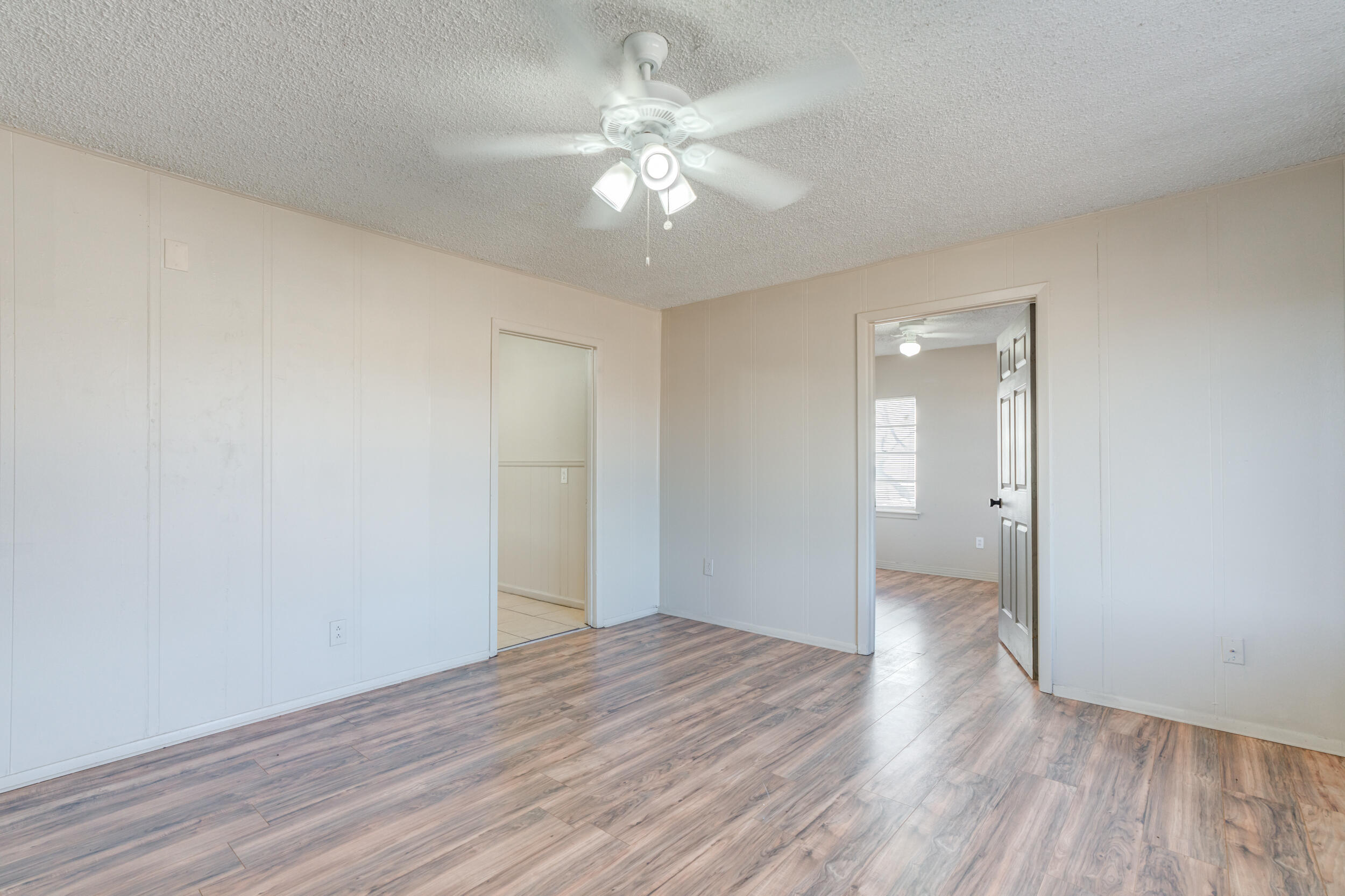 3109 Harvard Street Lubbock, TX 79415 - Photo 7 of 29 a view of an empty room with wooden floor