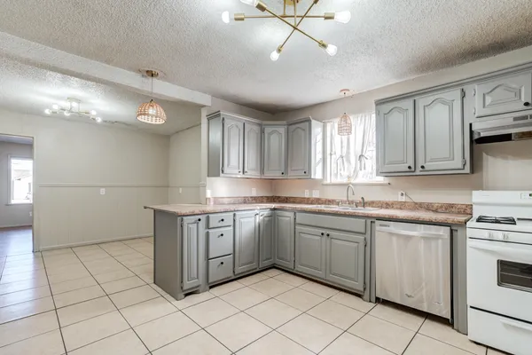 a kitchen with a sink window and cabinets
