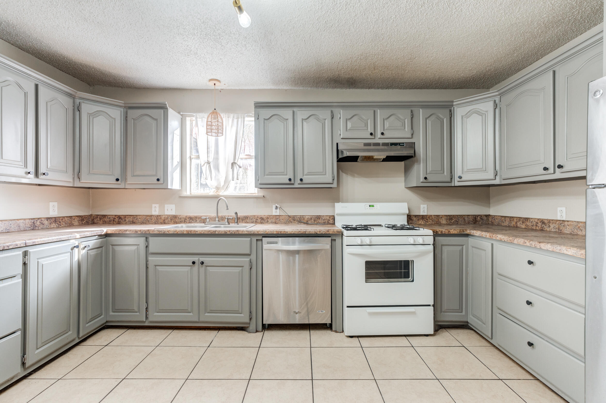 3109 Harvard Street Lubbock, TX 79415 - Photo 9 of 29 a kitchen with granite countertop white cabinets and white appliances