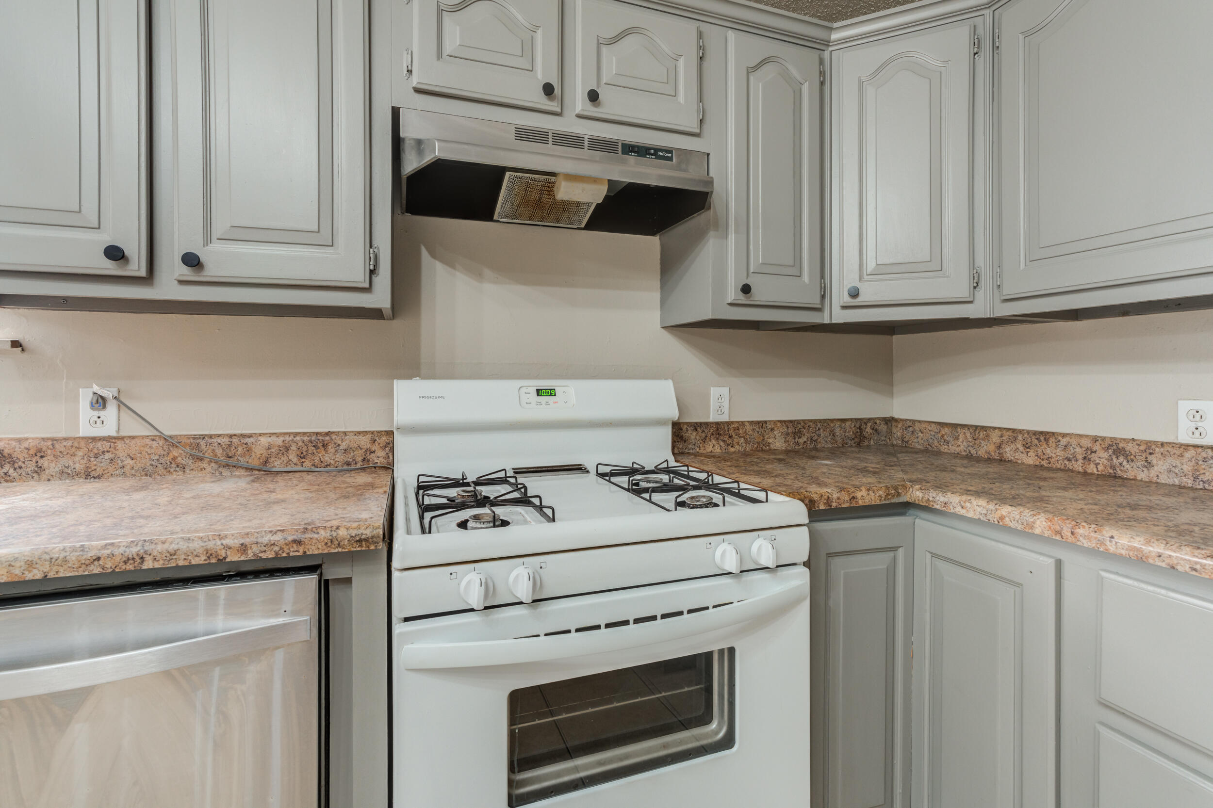 3109 Harvard Street Lubbock, TX 79415 - Photo 10 of 29 a kitchen with granite countertop white cabinets and white appliances