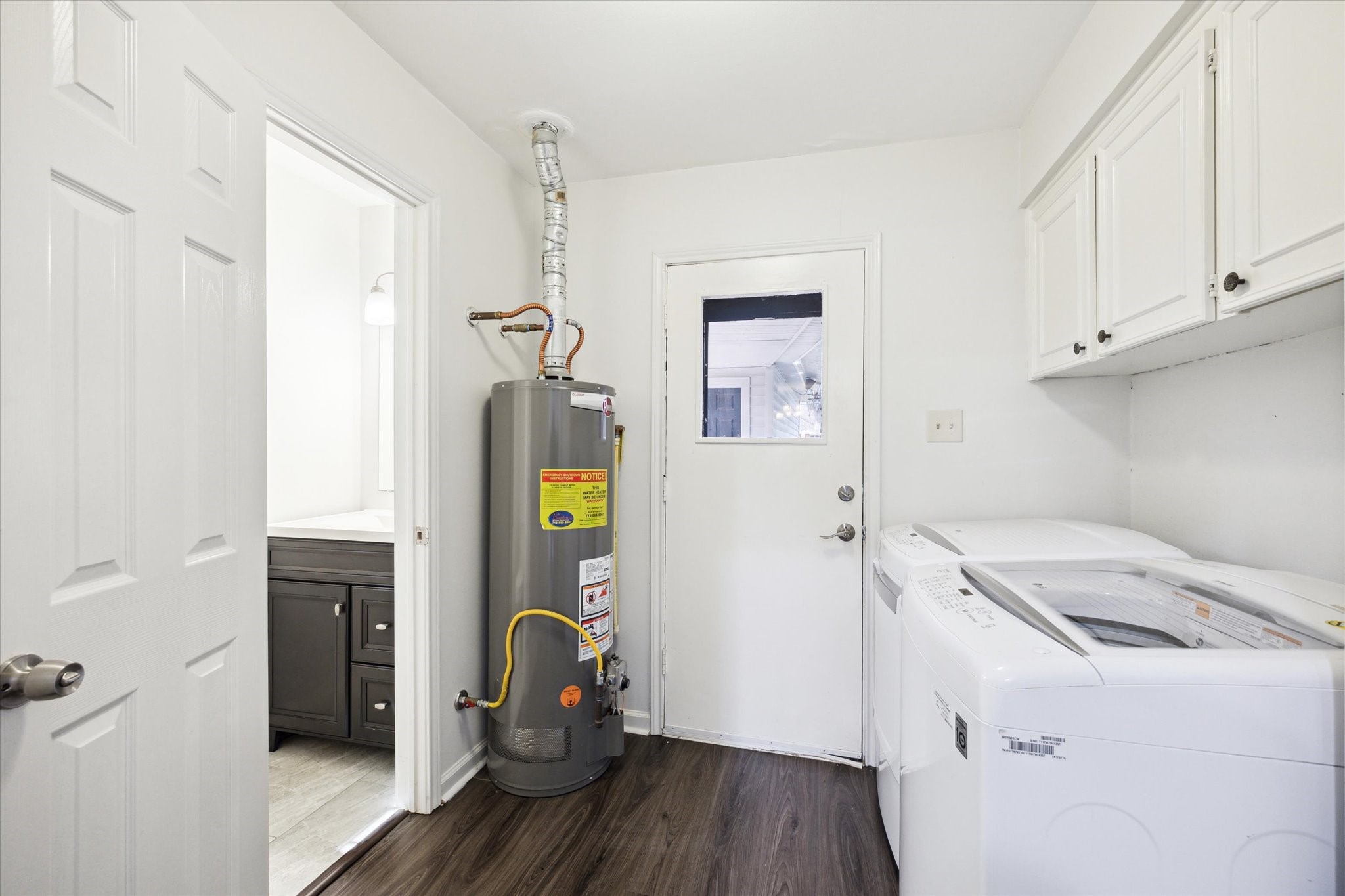 7614 Braesview Lane Houston, TX 77071 - Photo 17 of 29 a storage room with wooden floor and cabinets