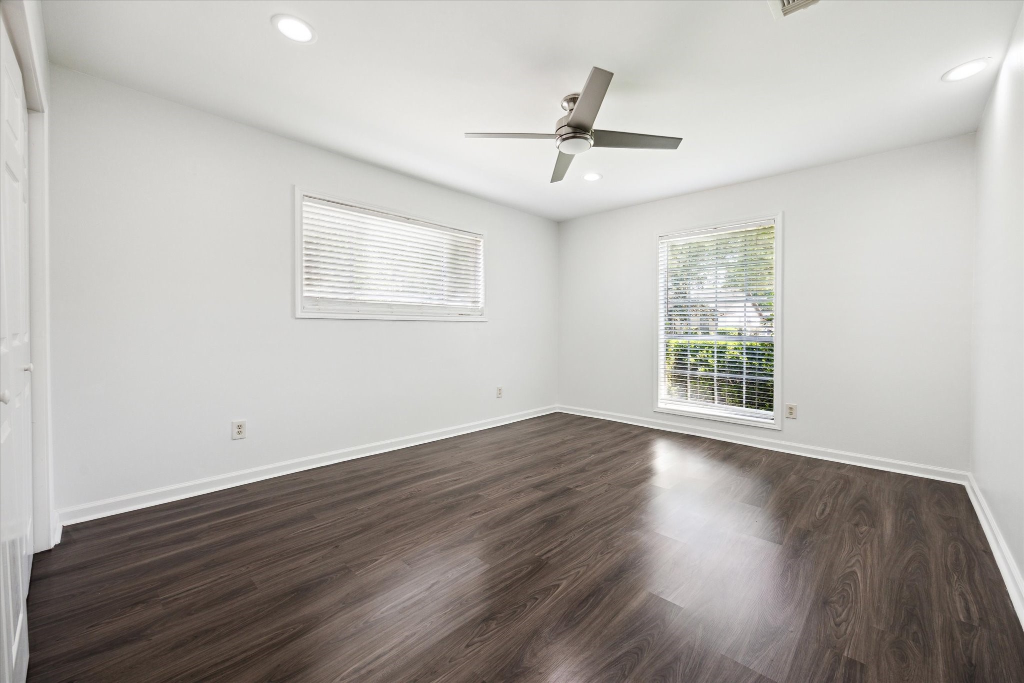 7614 Braesview Lane Houston, TX 77071 - Photo 22 of 29 a view of empty room with wooden floor and fan