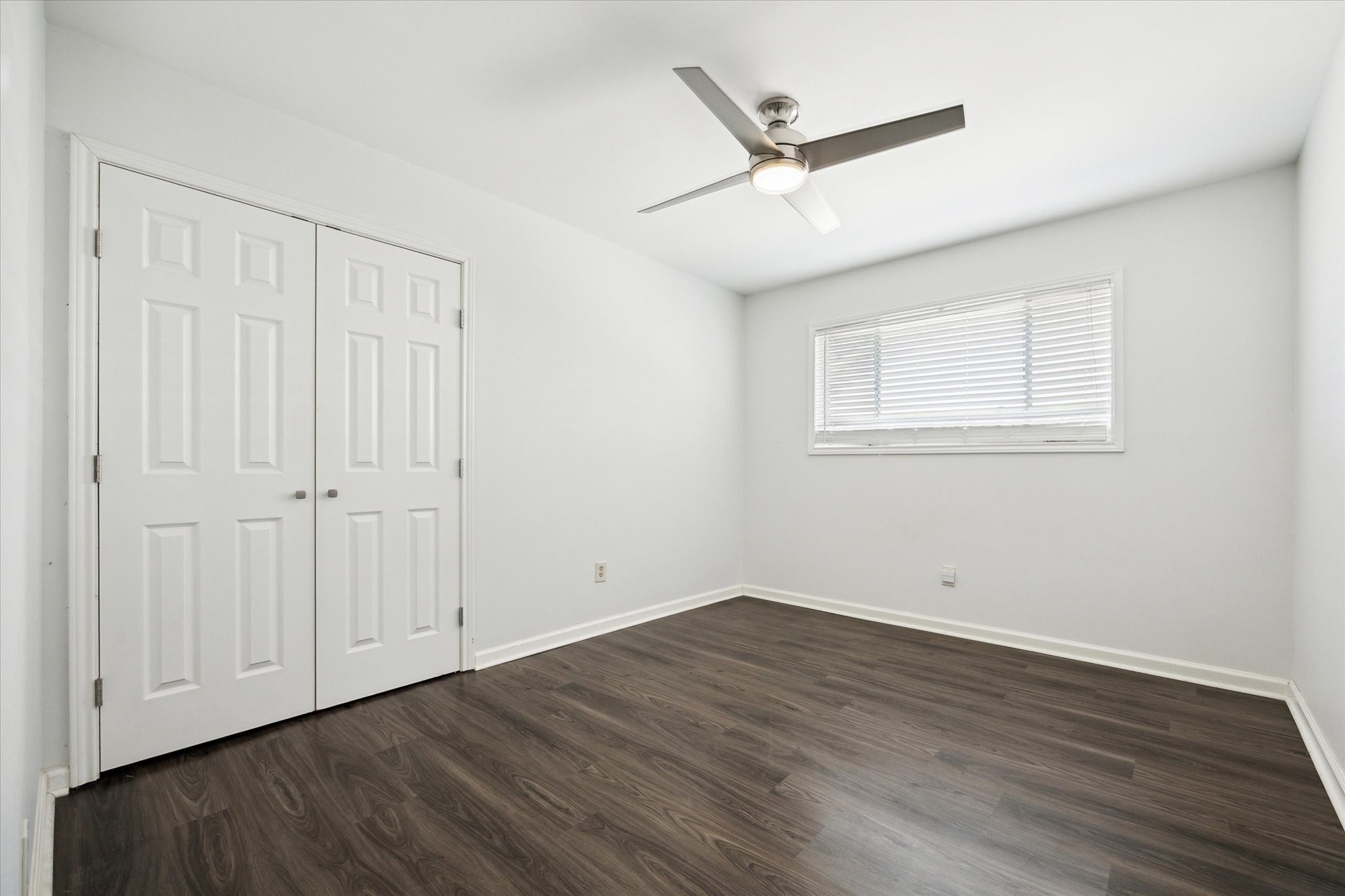 7614 Braesview Lane Houston, TX 77071 - Photo 24 of 29 an empty room with wooden floor fan and windows