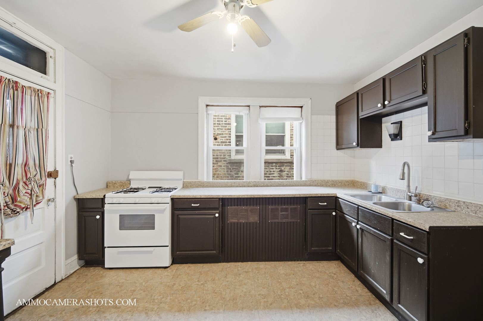 2045 West Farragut Avenue, Unit 3 Chicago, IL 60625 - Photo 17 of 32 a kitchen with a stove top oven sink and cabinets