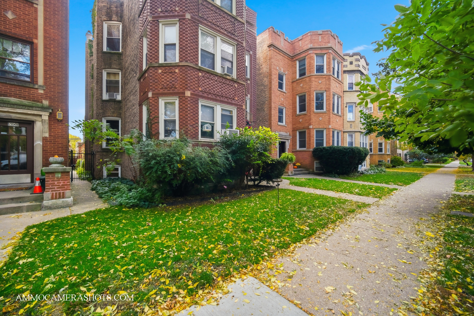 2045 West Farragut Avenue, Unit 3 Chicago, IL 60625 - Photo 3 of 32 a front view of a multi story residential apartment building with yard and green space