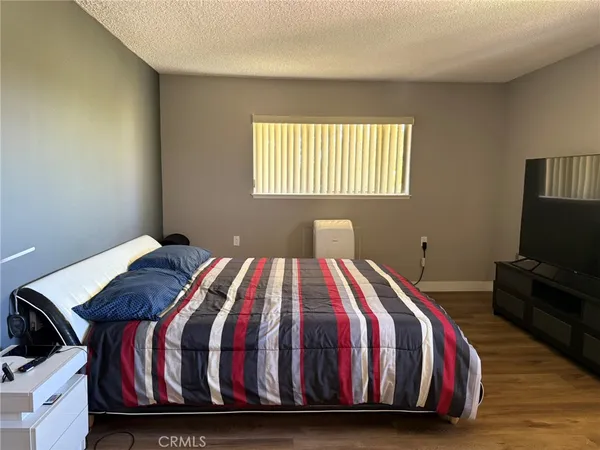 a bedroom with a bed and a flat screen tv