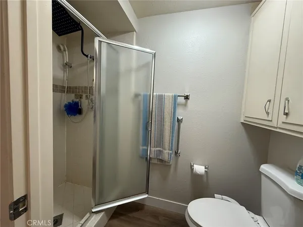 a bathroom with a toilet and a shower