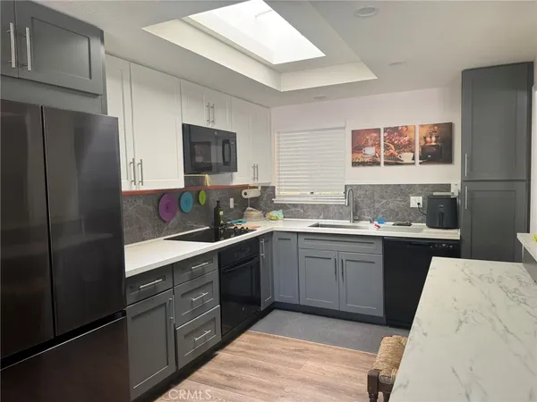 a kitchen with a sink stove and refrigerator