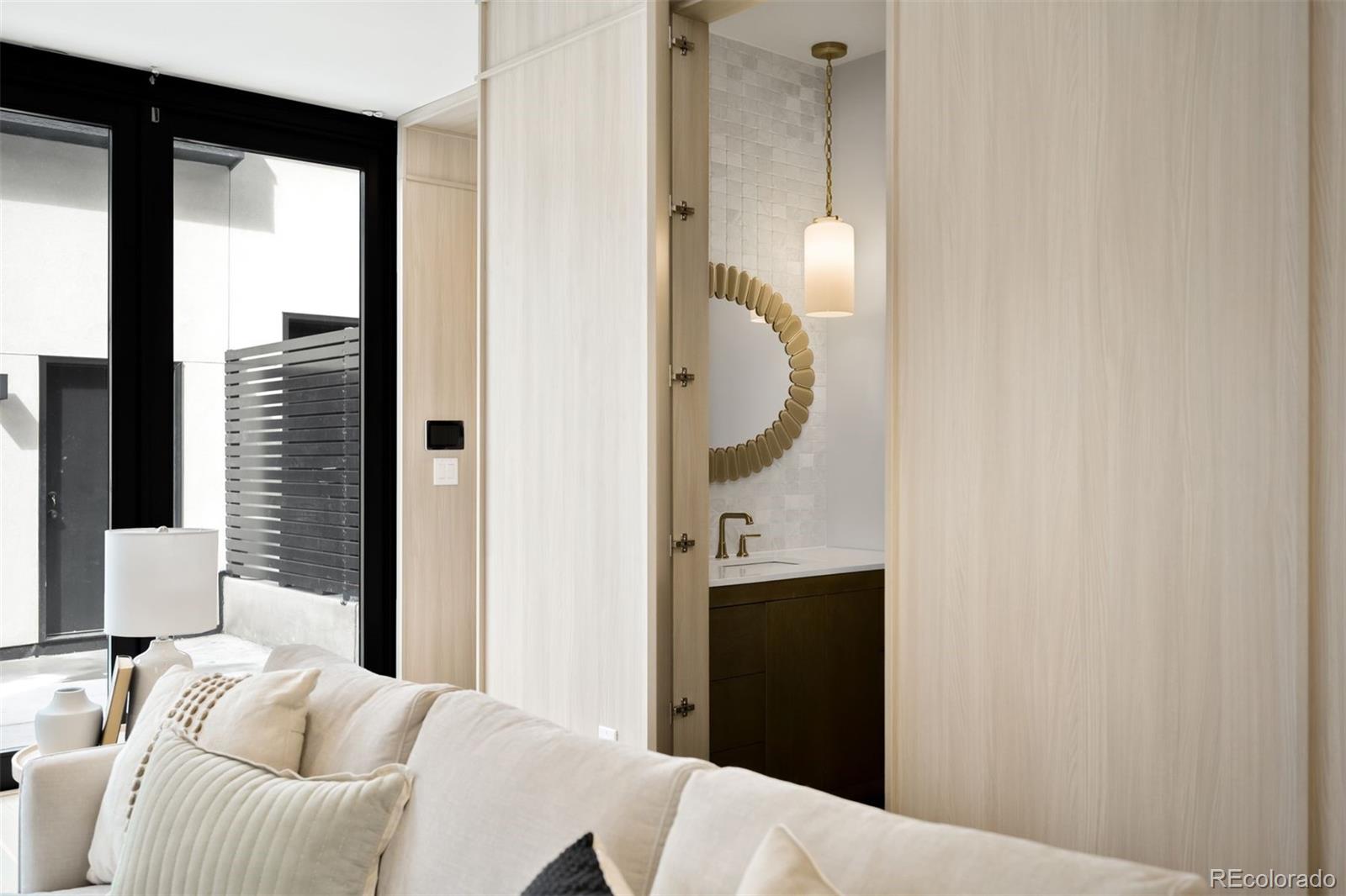 411 Madison Street Denver, CO 80206 - Photo 12 of 38 a bedroom with a bed and a mirror