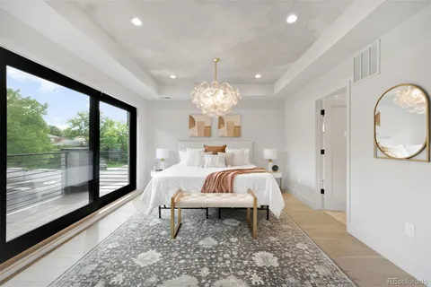 a bed room with furniture and a large window