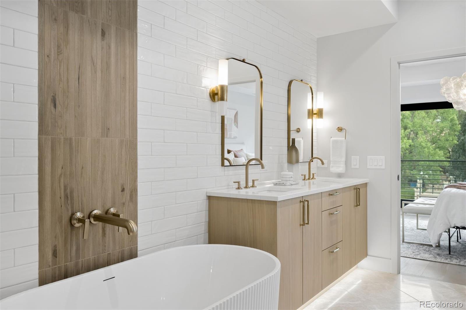 411 Madison Street Denver, CO 80206 - Photo 18 of 38 a bathroom with a double vanity sink and mirror