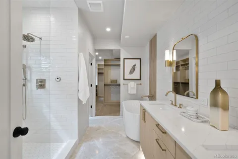 a bathroom with a double vanity sink mirror and shower