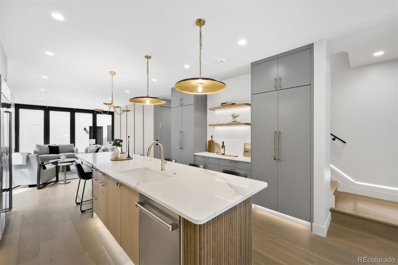 411 Madison Street Denver, CO 80206 - Photo 6 of 38 a kitchen with a sink a refrigerator and wooden floor