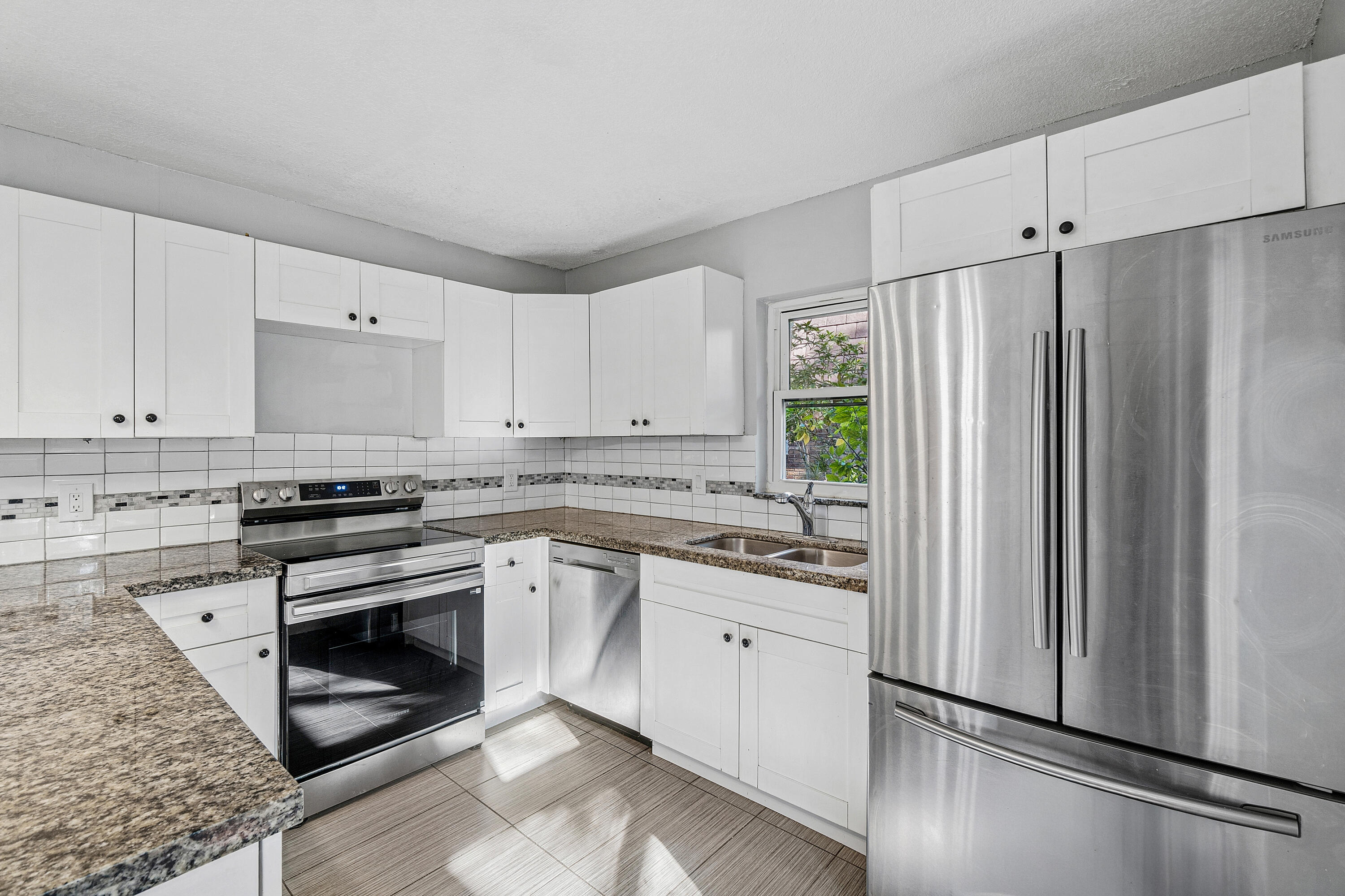 7536 Courtyard Run East Boca Raton, FL 33433 - Photo 11 of 25 a kitchen with stainless steel appliances granite countertop a refrigerator sink and stove