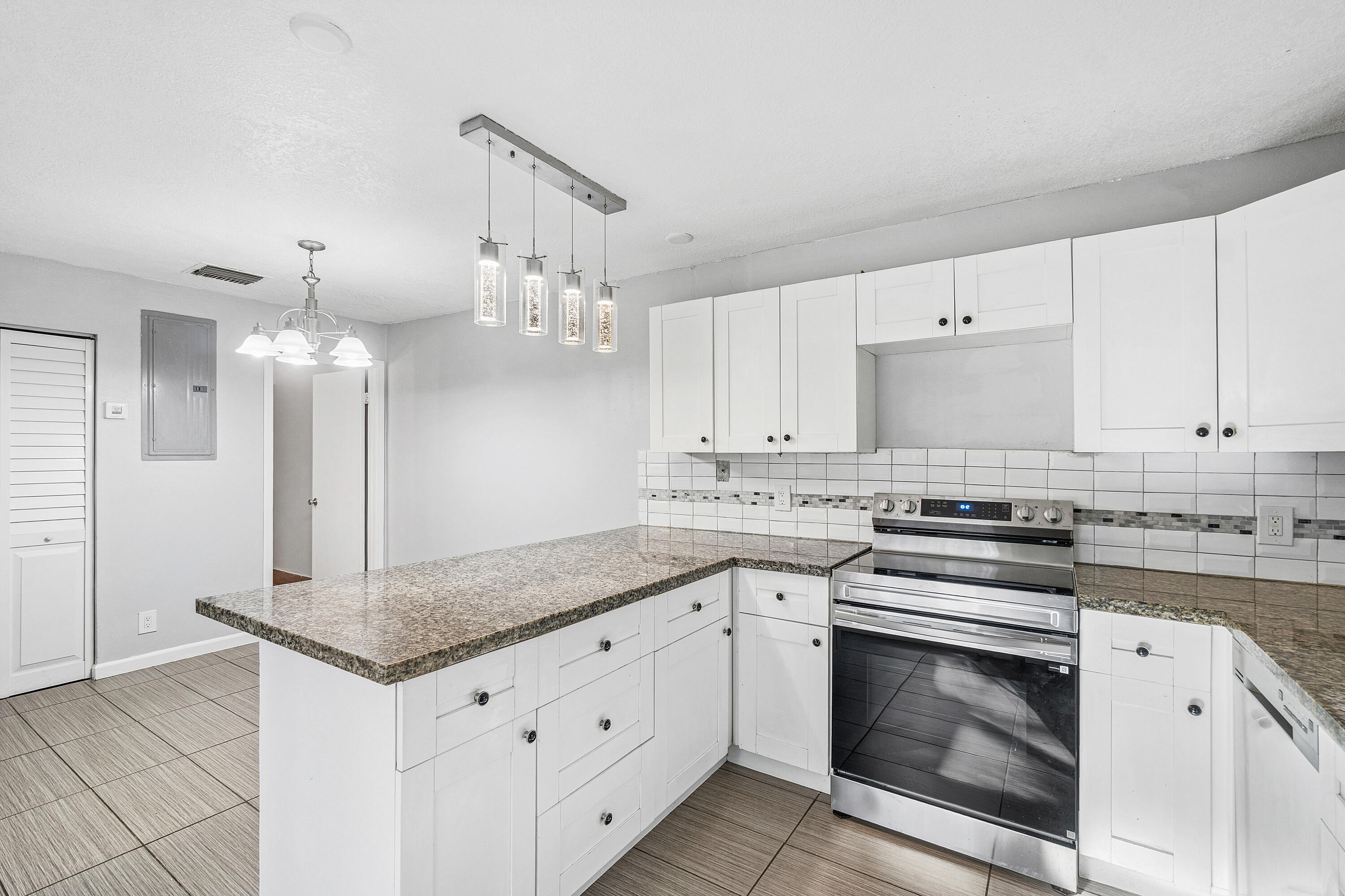7536 Courtyard Run East Boca Raton, FL 33433 - Photo 13 of 25 a kitchen with granite countertop white cabinets white stainless steel appliances with a sink and dishwasher