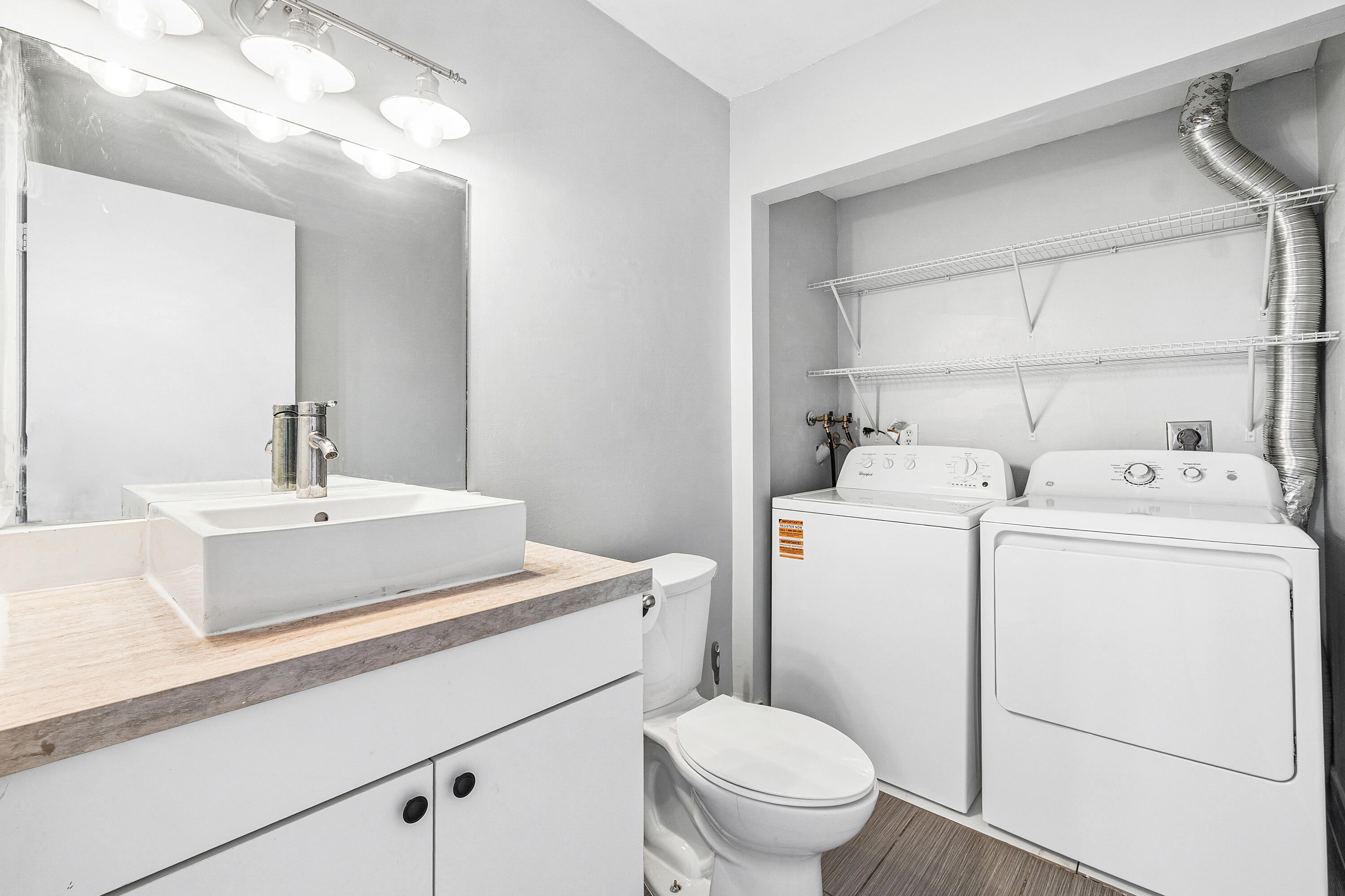 7536 Courtyard Run East Boca Raton, FL 33433 - Photo 16 of 25 a bathroom with a sink toilet and a mirror