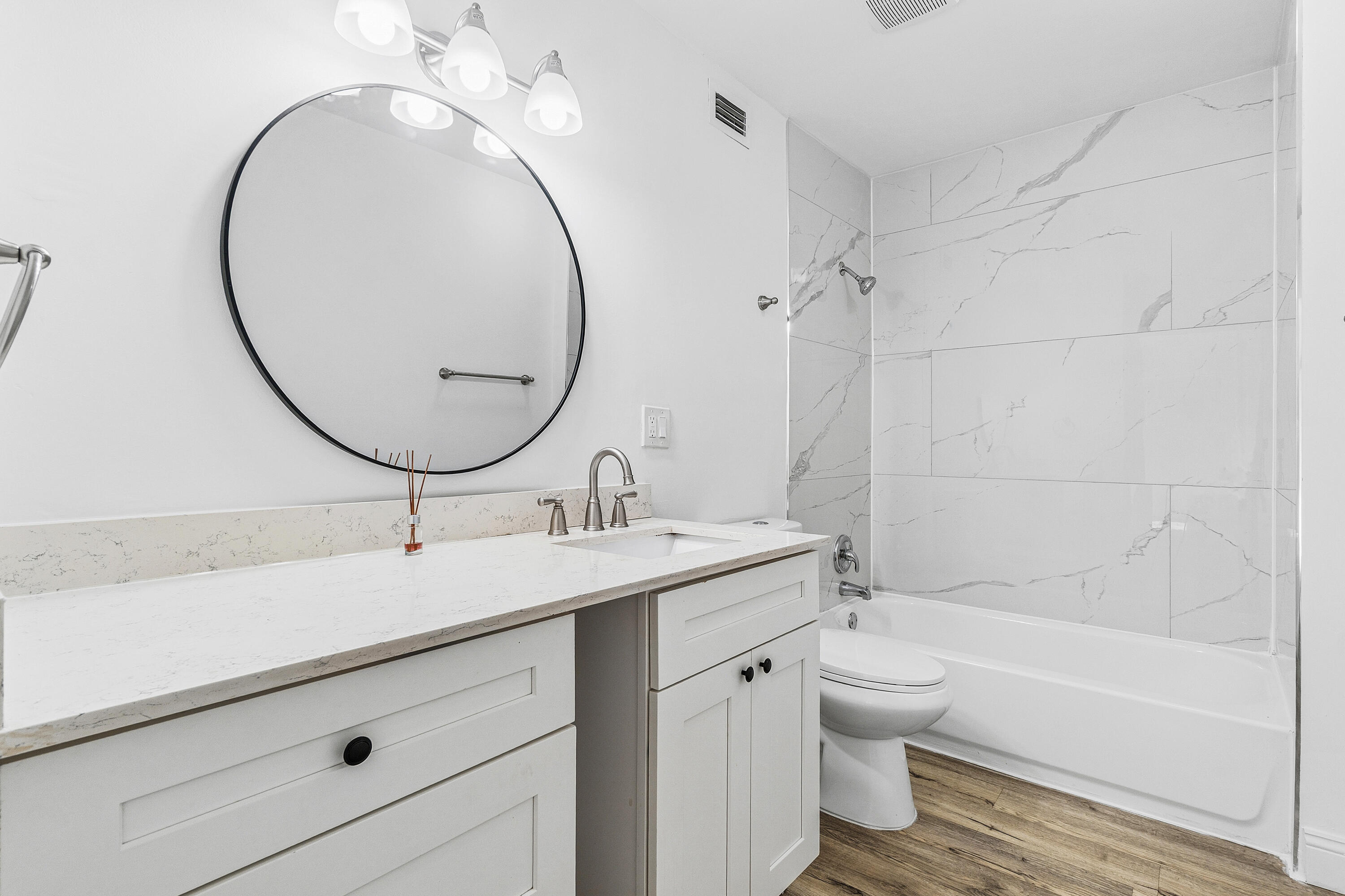 7536 Courtyard Run East Boca Raton, FL 33433 - Photo 17 of 25 a bathroom with a sink a toilet and a mirror