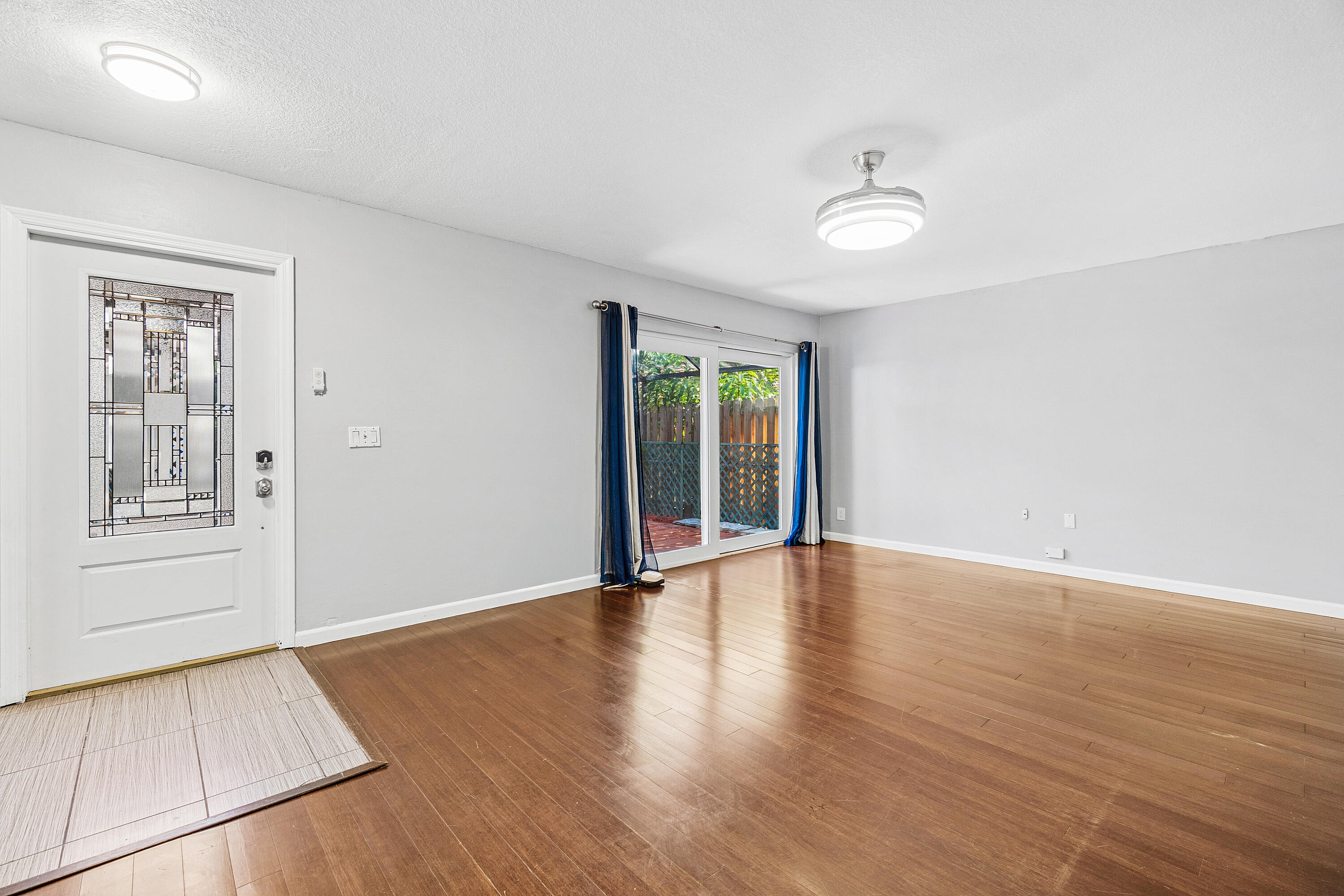 7536 Courtyard Run East Boca Raton, FL 33433 - Photo 6 of 25 an empty room with wooden floor and windows
