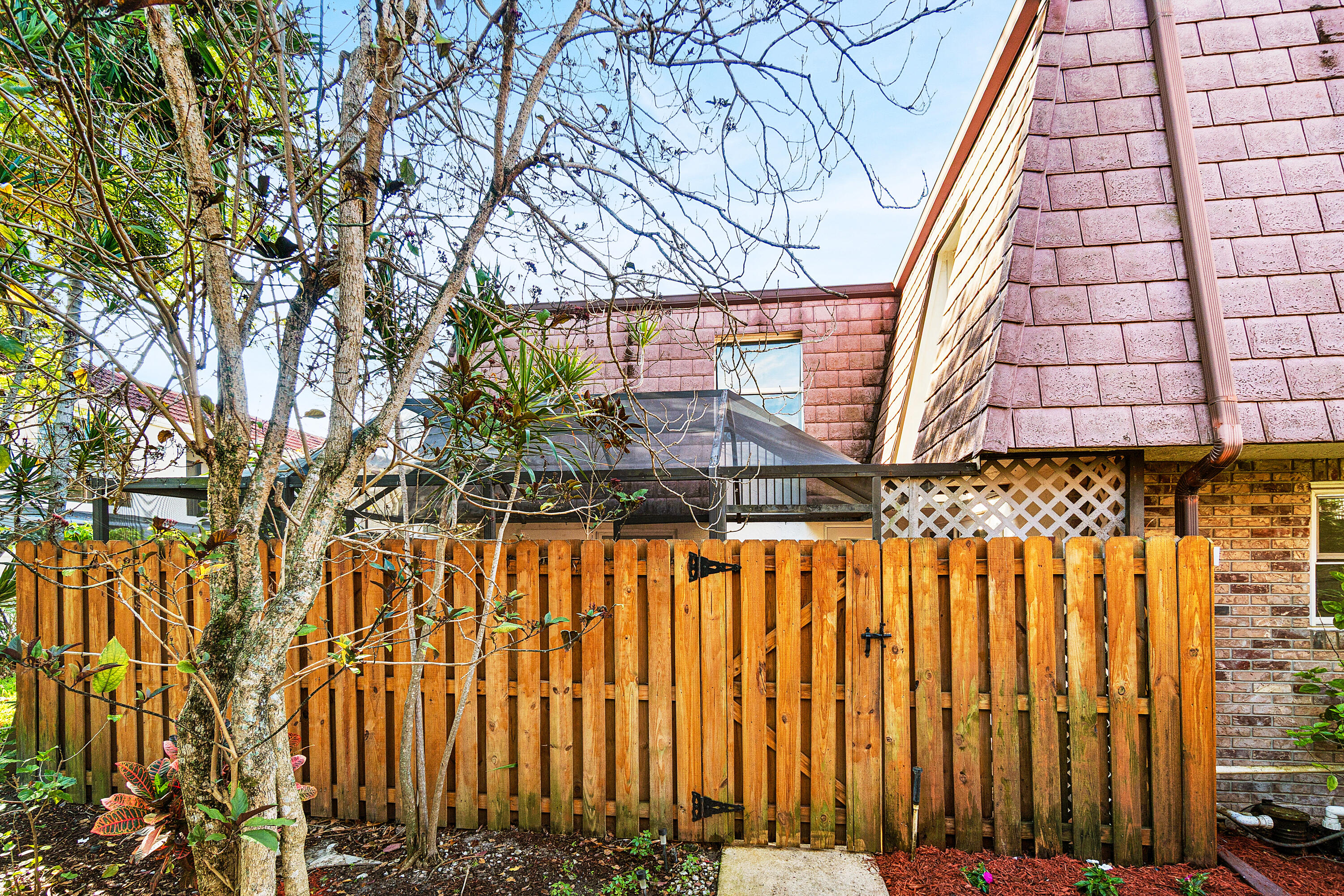 7536 Courtyard Run East Boca Raton, FL 33433 - Photo 10 of 25 a view of a pathway with a wooden fence