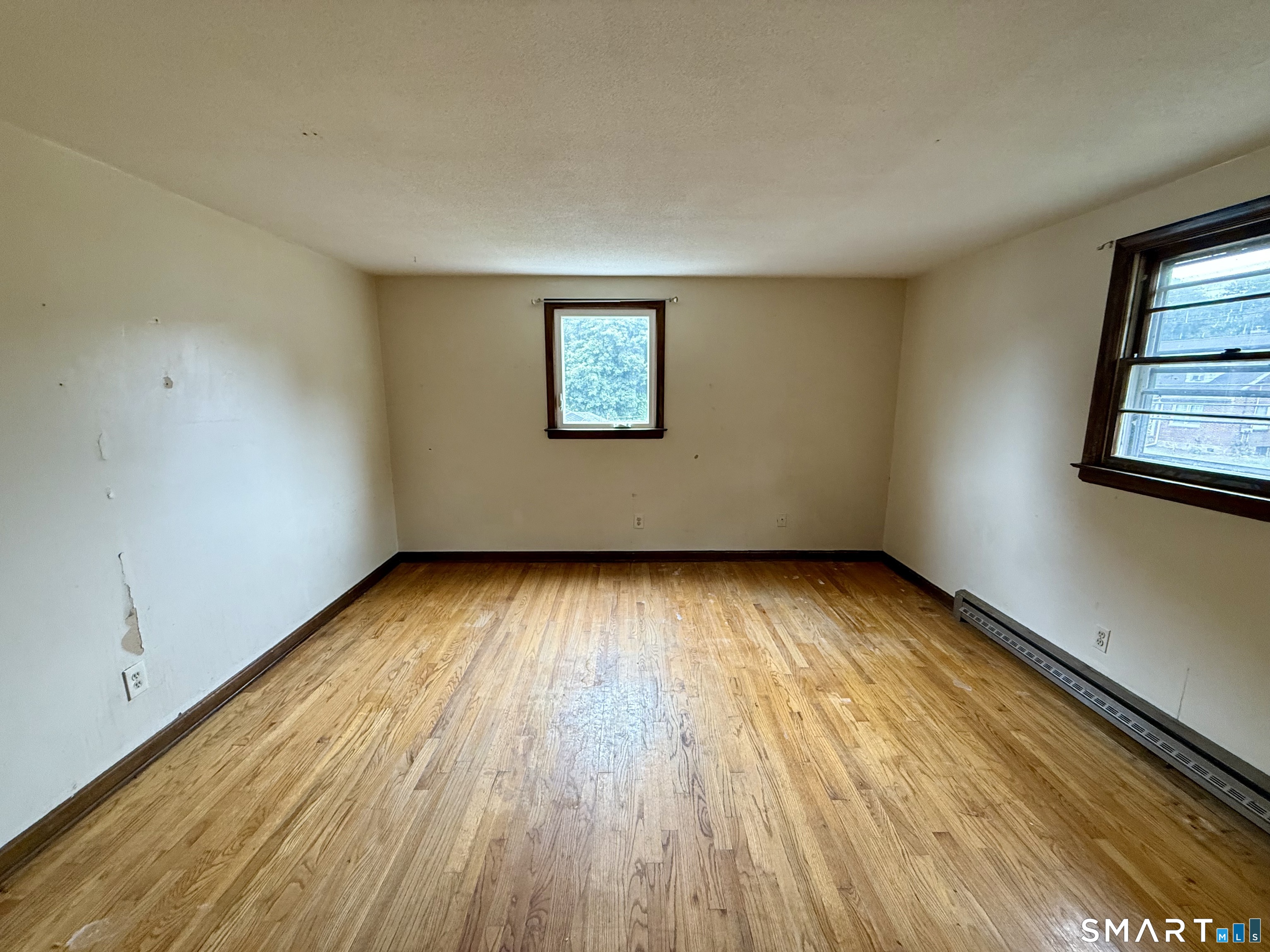 400 Divinity Street Bristol, CT 06010 - Photo 13 of 19 an empty room with wooden floor and windows