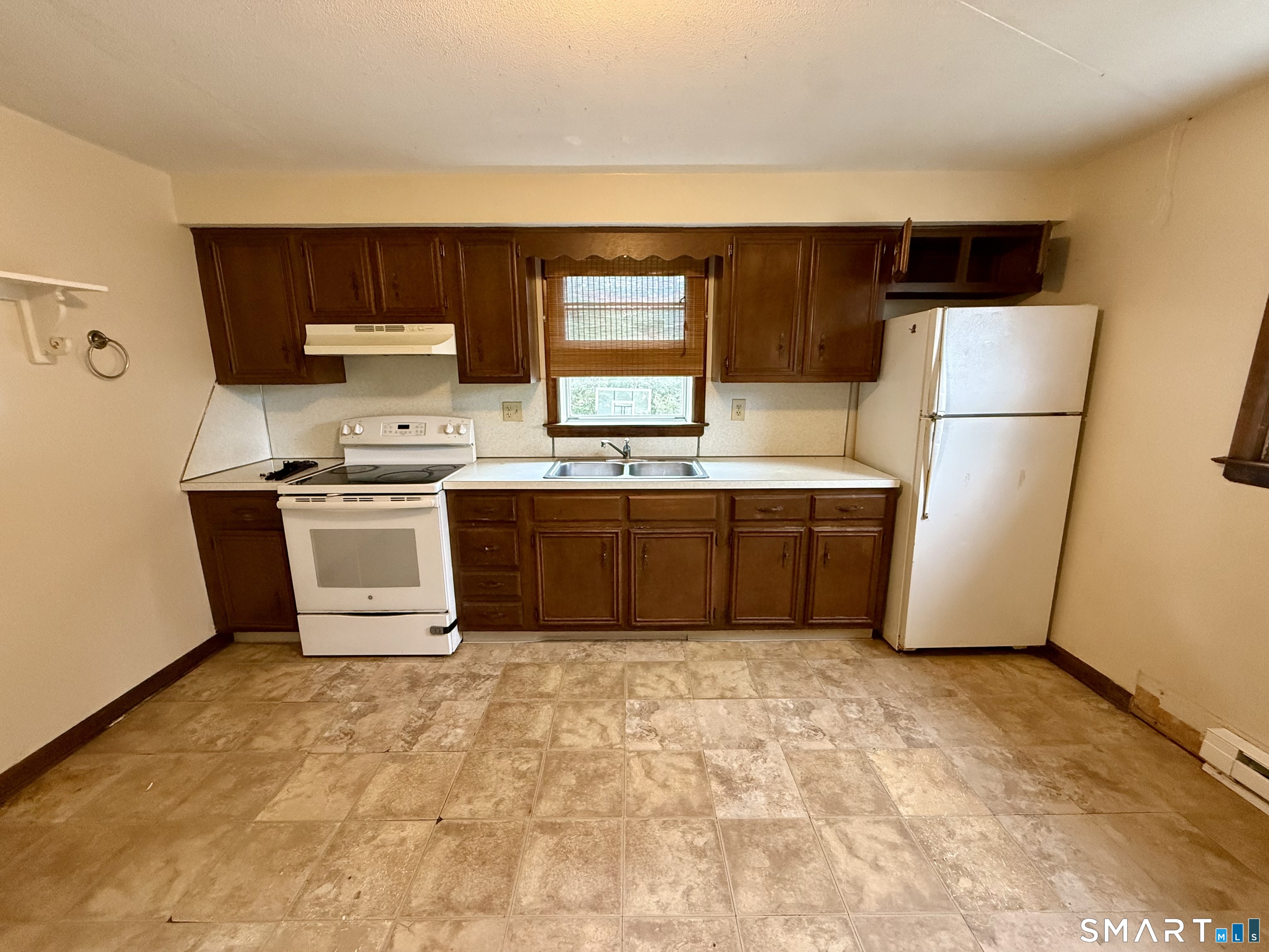 400 Divinity Street Bristol, CT 06010 - Photo 6 of 19 a kitchen with stainless steel appliances a stove a sink and a refrigerator