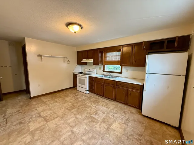 a kitchen with stainless steel appliances a refrigerator and a sink