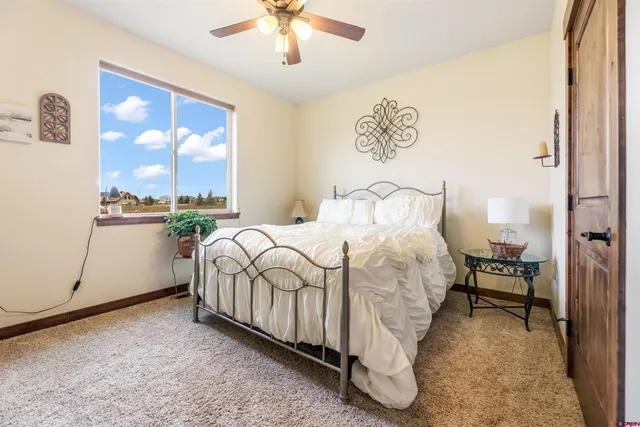 a bedroom with a bed and a potted plant